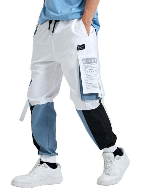 A person standing wearing white and black pants along with white shoes.