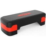 A black stapler with red text on its side, placed on a surface.