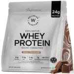 A package of protein powder labeled "100% Native Whey Protein Isolate + Concentrate" in Swiss Chocolate flavor, highlighting its nutritional content with 24g of protein, 11.5g of EAAs, 5.4g of BCAAs, and additional features like probiotics and a claim about muscle strength increase. The net weight is indicated as 1kg (2.2lb).