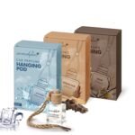 Alt text: A box of hanging car perfume labeled "Musk Intense Oud" and "Icy Blast", featuring a refreshing design. The packaging includes details about the product and its scent.